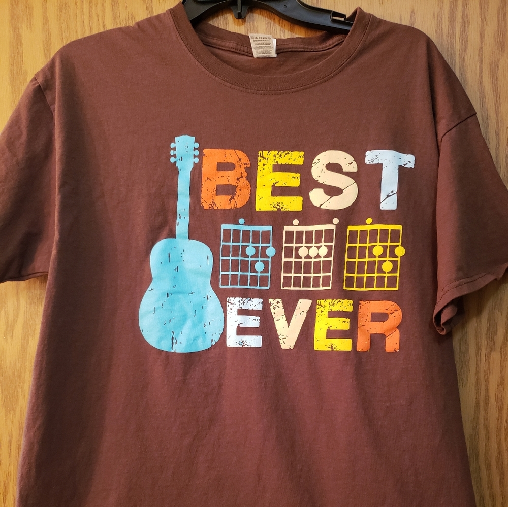 Men's brown t-shirt with "best dad ever" on the front with guitar. Never worn.
